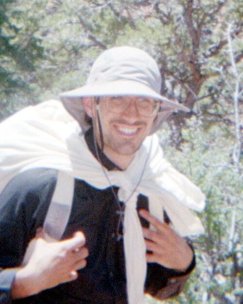 Maddox Schmidlkofer hiking in a red-rock canyon.